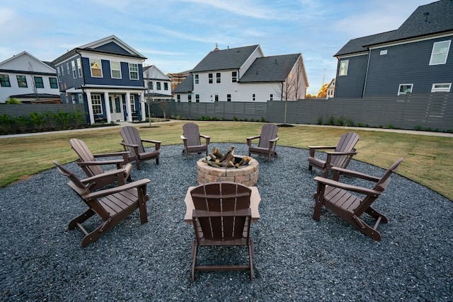 surrounding community featuring a lawn and an outdoor fire pit