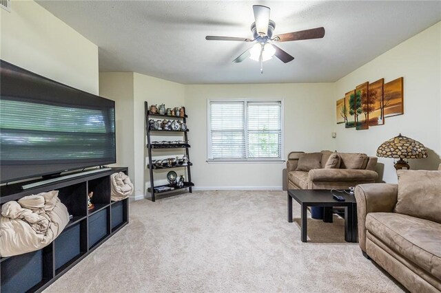 carpeted living room featuring ceiling fan