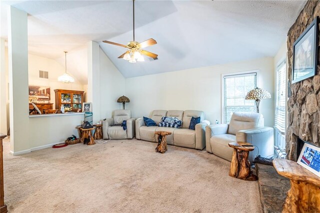 living room with ceiling fan, a fireplace, carpet, and high vaulted ceiling