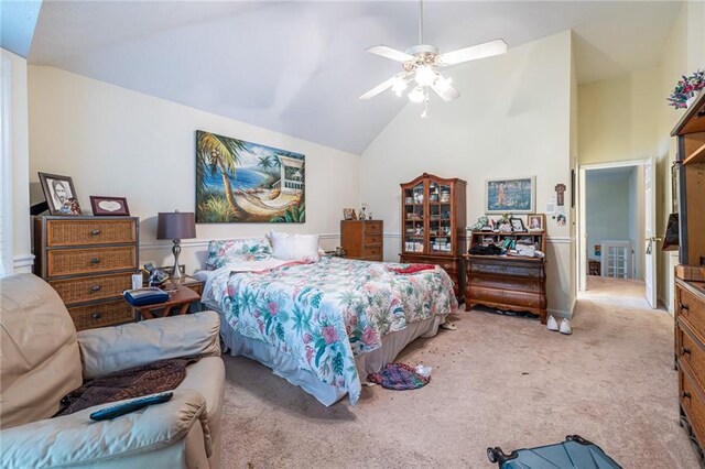 carpeted bedroom featuring ceiling fan and high vaulted ceiling