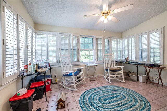 sunroom with lofted ceiling and ceiling fan