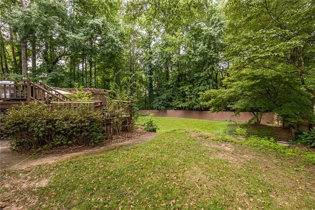 view of yard featuring a wooden deck