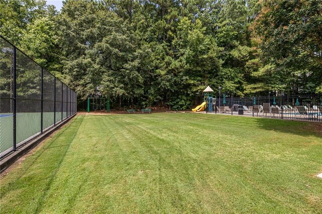 view of yard featuring a swimming pool and a playground