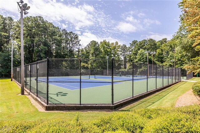 view of sport court featuring a yard