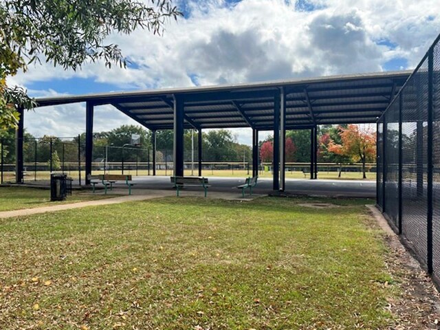 view of parking featuring a yard and a carport