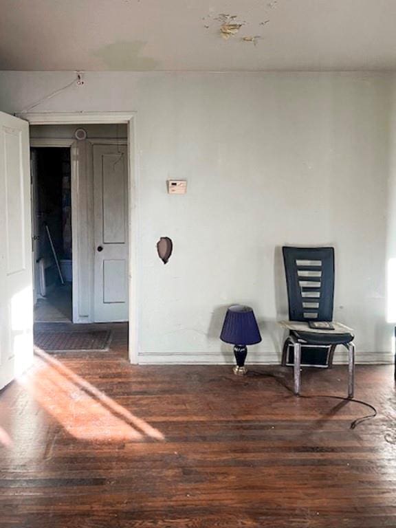 sitting room with dark wood-type flooring