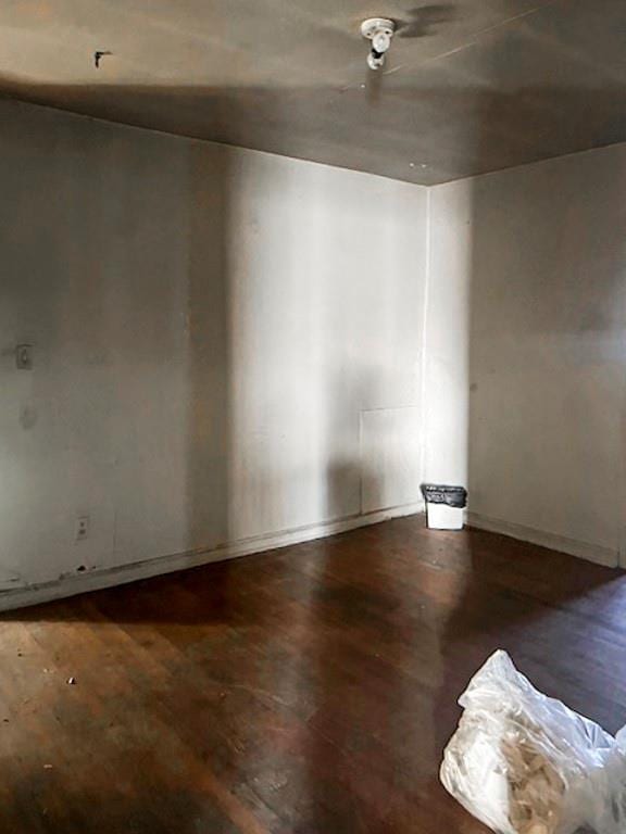 spare room featuring dark hardwood / wood-style flooring