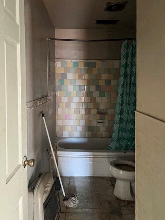 bathroom with shower / bath combo and toilet