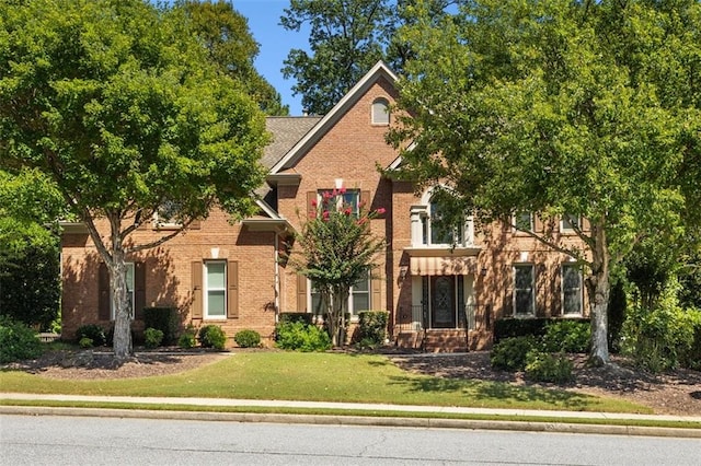 385 Guildhall Grv, Johns Creek, GA 30022 - view of front facade with brick siding and a front lawn