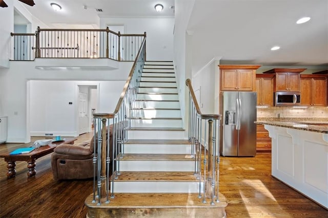 385 Guildhall Grv, Johns Creek, GA 30022 - stairs with wood finished floors, crown molding, a ceiling fan, recessed lighting, and a high ceiling