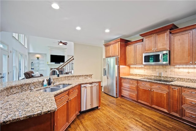 385 Guildhall Grv, Johns Creek, GA 30022 - kitchen featuring stainless steel appliances, a sink, light wood-style flooring, ceiling fan, and light stone countertops