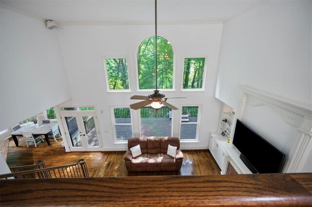 385 Guildhall Grv, Johns Creek, GA 30022 - living room with crown molding, ceiling fan, wood finished floors, a towering ceiling, and french doors
