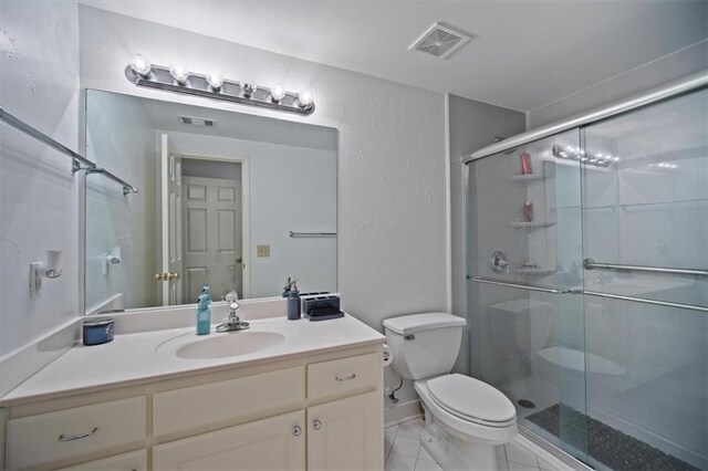 385 Guildhall Grv, Johns Creek, GA 30022 - bathroom with toilet, a shower stall, a textured wall, and vanity