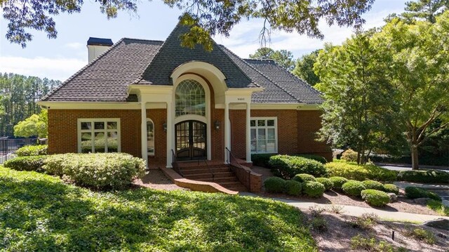 385 Guildhall Grv, Johns Creek, GA 30022 - french country style house featuring french doors, a chimney, and brick siding