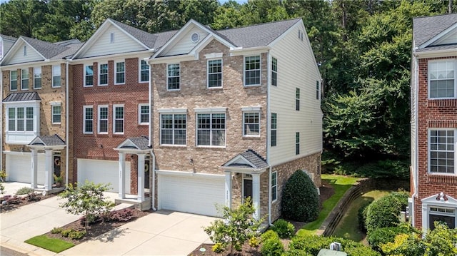 3733 Chattahoochee Summit Dr SE Unit 7, Atlanta, GA 30339 - view of front of home featuring an attached garage, concrete driveway, and brick siding