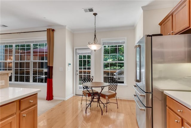 3733 Chattahoochee Summit Dr SE Unit 7, Atlanta, GA 30339 - kitchen with freestanding refrigerator, light wood-style flooring, ornamental molding, hanging light fixtures, and light countertops