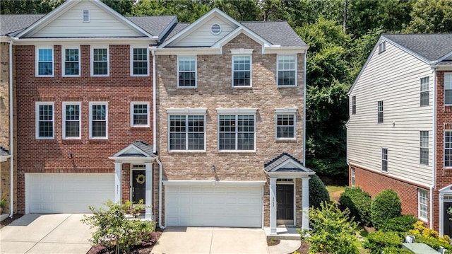 3733 Chattahoochee Summit Dr SE Unit 7, Atlanta, GA 30339 - view of front of house featuring a garage, driveway, and brick siding