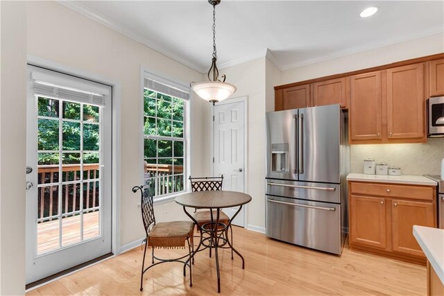 3733 Chattahoochee Summit Dr SE Unit 7, Atlanta, GA 30339 - kitchen featuring stainless steel appliances, light wood-style flooring, tasteful backsplash, light countertops, and ornamental molding