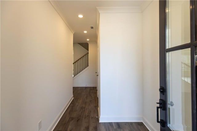 hallway with dark hardwood / wood-style flooring and crown molding