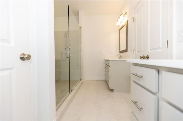 bathroom featuring vanity and a shower with shower door