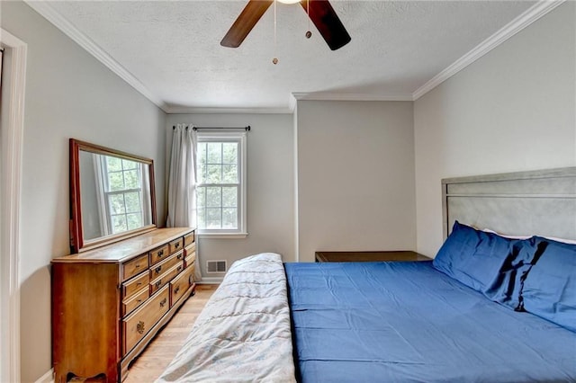 2121 Crescentview Dr, Lawrenceville, GA 30044 - bedroom featuring light wood-type flooring, a textured ceiling, crown molding, ceiling fan, and baseboards