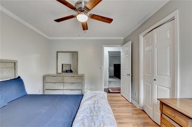 2121 Crescentview Dr, Lawrenceville, GA 30044 - bedroom with ornamental molding, light wood-style floors, a closet, ceiling fan, and baseboards