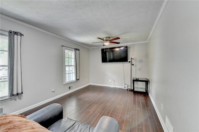 2121 Crescentview Dr, Lawrenceville, GA 30044 - living area featuring a textured ceiling, ornamental molding, a ceiling fan, baseboards, and dark wood-style flooring