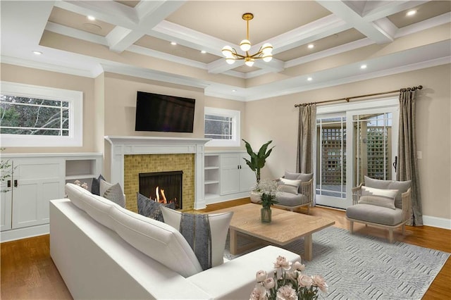 living area featuring a wealth of natural light, dark wood finished floors, and coffered ceiling