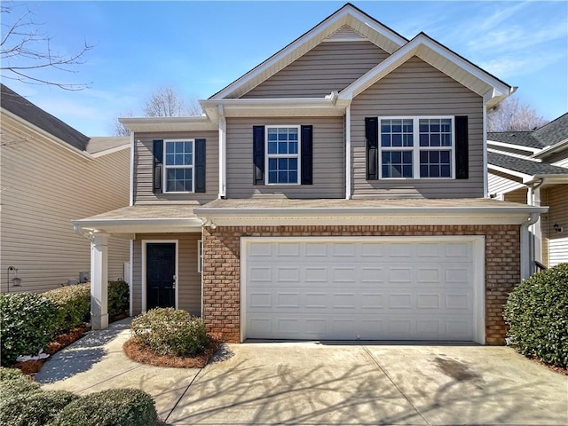 view of front of home with concrete driveway, an attached garage, and brick siding