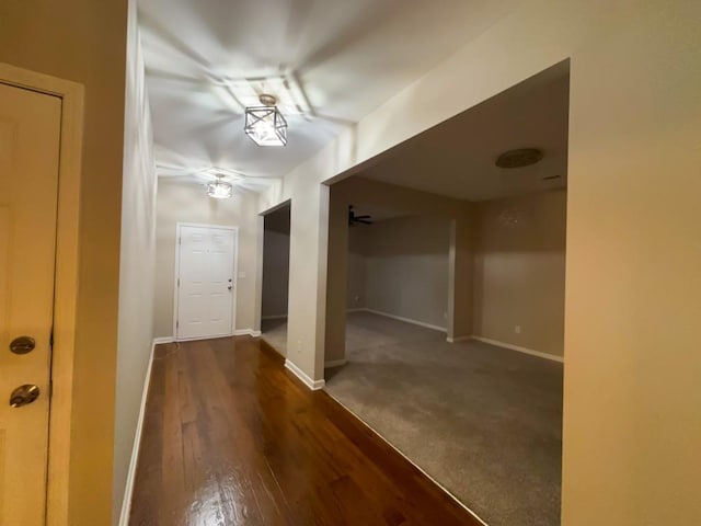 hallway with dark hardwood / wood-style flooring