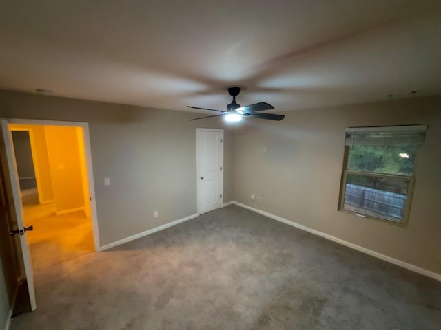 unfurnished bedroom featuring ceiling fan and carpet