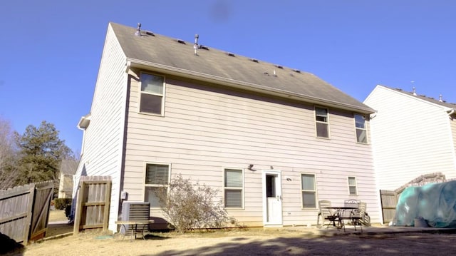 rear view of property with central AC and a patio area