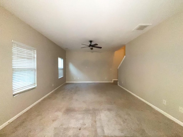 spare room featuring carpet floors and ceiling fan