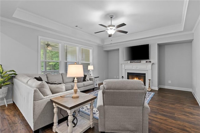 5116 Chastain Way, Gainesville, GA 30507 - living area with a warm lit fireplace, crown molding, ceiling fan, a raised ceiling, and dark wood-style flooring