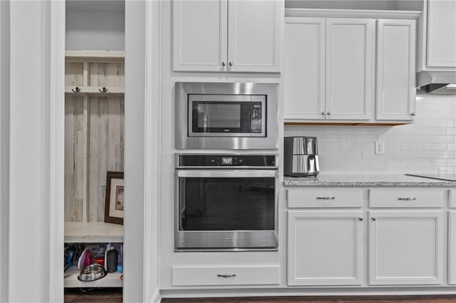 5116 Chastain Way, Gainesville, GA 30507 - kitchen featuring stainless steel appliances, white cabinetry, wall chimney range hood, light stone countertops, and backsplash