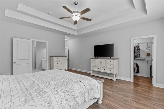 5116 Chastain Way, Gainesville, GA 30507 - bedroom featuring a raised ceiling, ornamental molding, a spacious closet, and wood finished floors