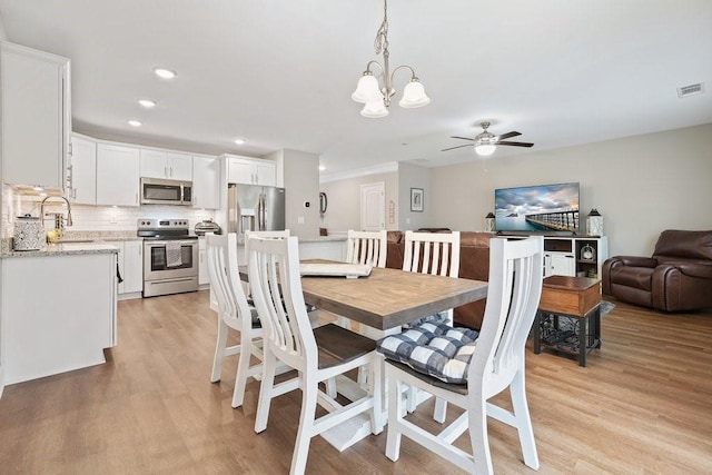 dining area with ceiling fan with notable chandelier, light wood-type flooring, visible vents, and recessed lighting