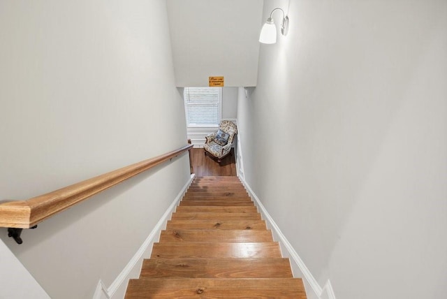 stairs with baseboards and wood finished floors