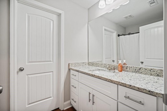 full bathroom with visible vents and vanity