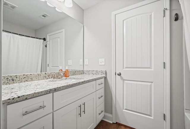 bathroom with visible vents and vanity