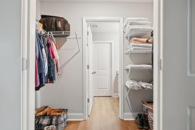 spacious closet with visible vents and light wood-style flooring