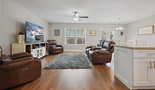 living room featuring ceiling fan and wood finished floors