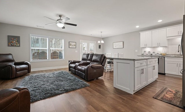 interior space with dark wood-style floors, open floor plan, and white cabinetry