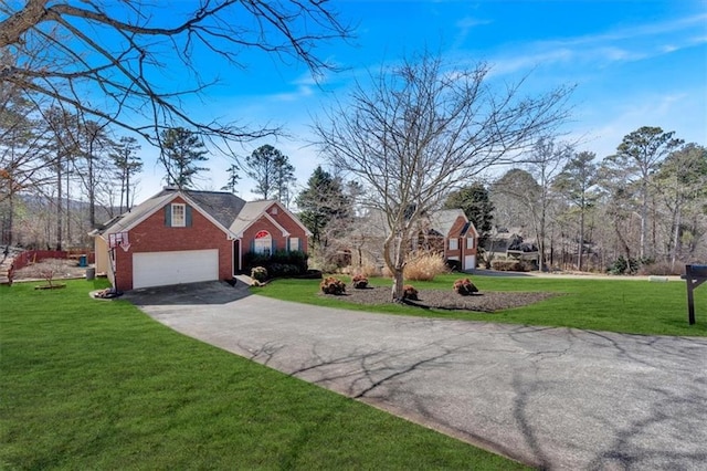 view of front facade with driveway, brick siding, a garage, and a front yard