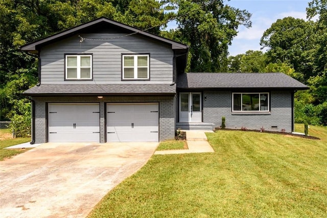 tri-level home with a garage and a front yard