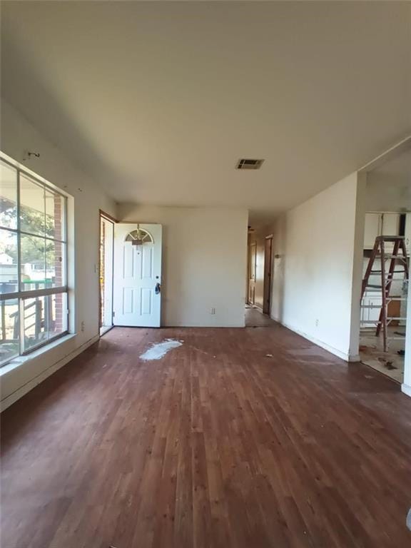 unfurnished living room featuring dark hardwood / wood-style floors