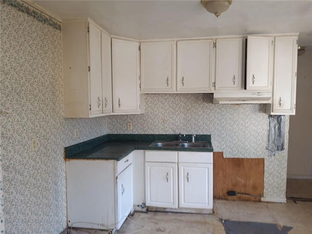 kitchen featuring white cabinets, tasteful backsplash, and sink