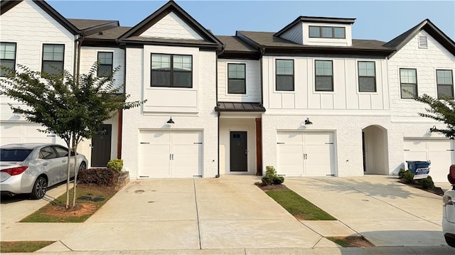32 S Auburn Landing Pl, Auburn, GA 30011 - townhome / multi-family property with an attached garage, driveway, brick siding, and board and batten siding