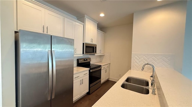 32 S Auburn Landing Pl, Auburn, GA 30011 - kitchen with appliances with stainless steel finishes, a sink, tasteful backsplash, recessed lighting, and dark wood-style flooring