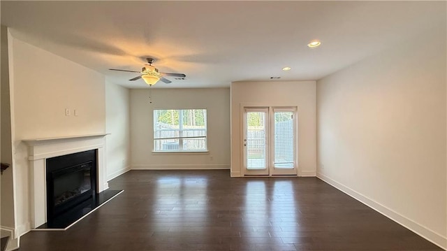 32 S Auburn Landing Pl, Auburn, GA 30011 - unfurnished living room with a ceiling fan, a glass covered fireplace, baseboards, dark wood-type flooring, and recessed lighting